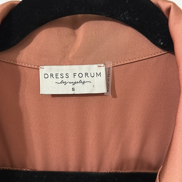 This silky romper is super cute. I am 5’5” & 135 lbs. it’s a salmon/ginger color - Picture 7 of 7